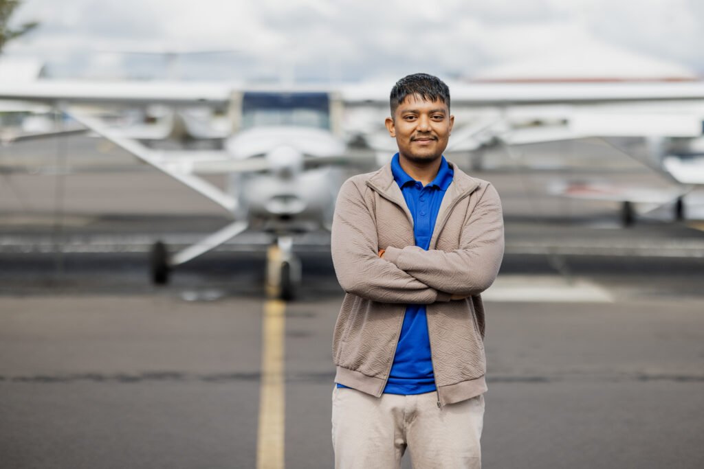 Sudisha Aviation Consultant student Susheel Rasaily standing in front of an aircraft during his Commercial Pilot training at Hillsboro Aero Academy, USA.