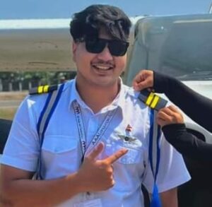 Nepali student pilot receiving PPL stripes during pinning ceremony at flight school